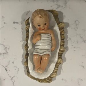 Hummel Baby Jesus in White and Brown bed.